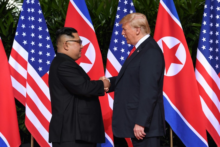 Trump, Kim share historic handshake, warm words