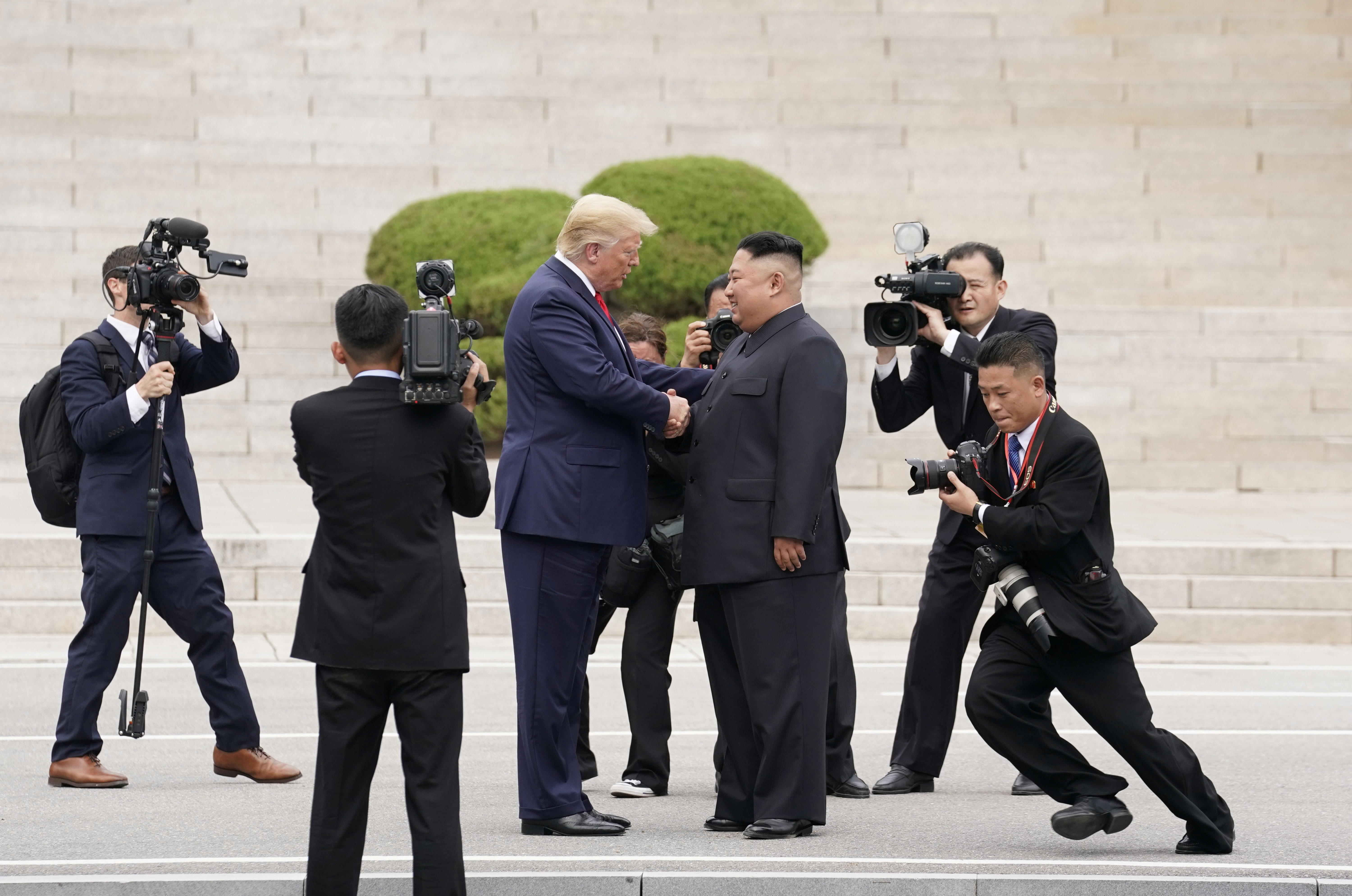 Trump sets foot in NKorea, agrees with Kim to resume talks