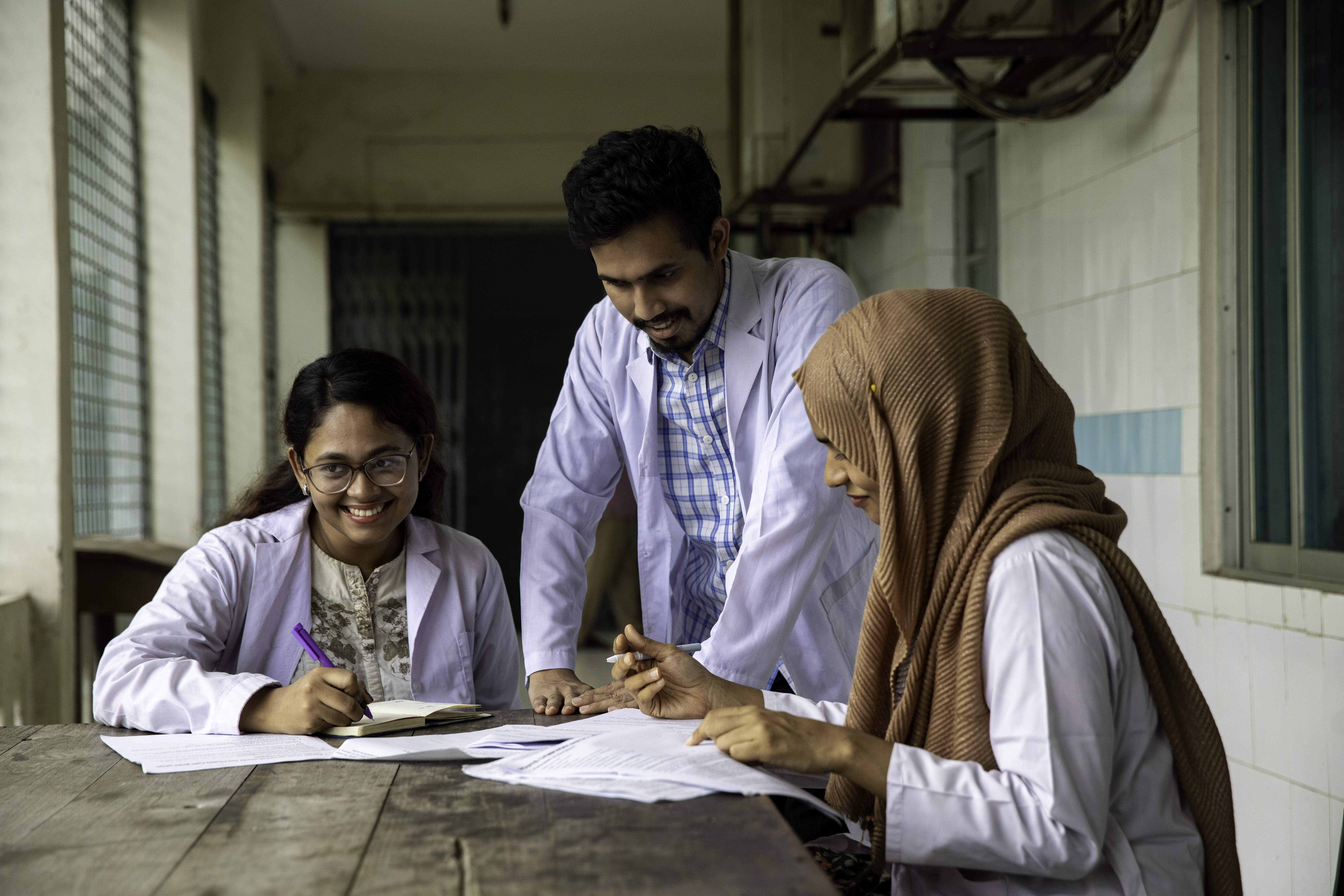 Medical students perusing through medical files and reports.