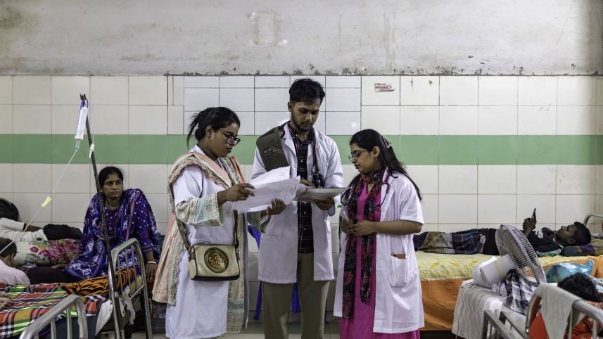 Medical interns examining reports. 