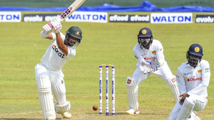 Najmul Hossain plays a shot as Sri Lanka's wicketkeeper Niroshan Dickwella (C) (1).jpg