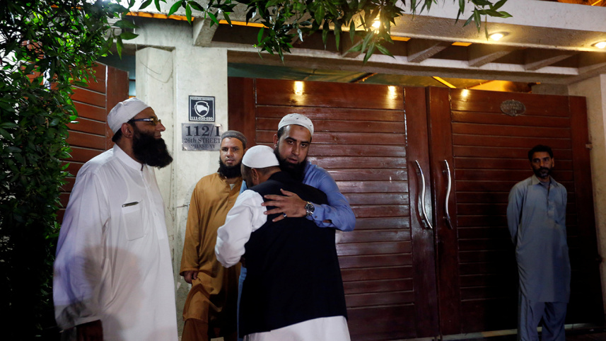 Relatives gather outside the residence of Junaid Jamshed