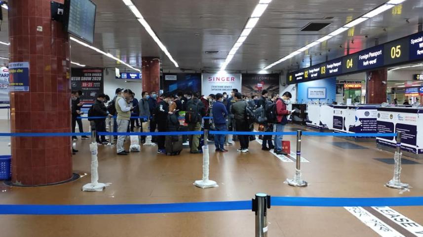 Passengers waiting in line at Dhaka airport