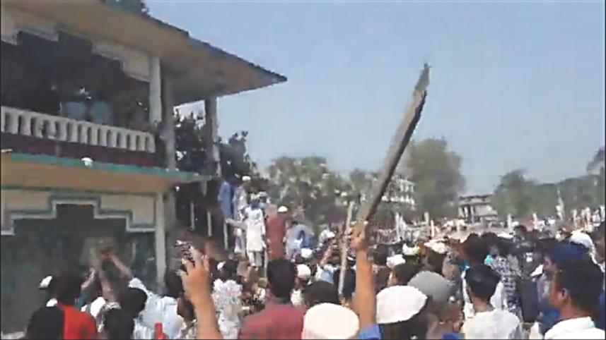A video grab shows a protester wielding a stick on Sunday