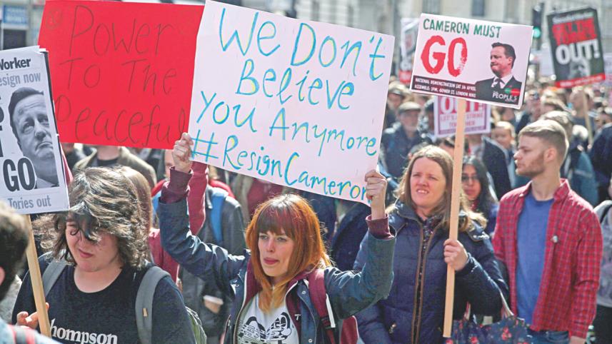 Demonstrators hold placards 1.jpg