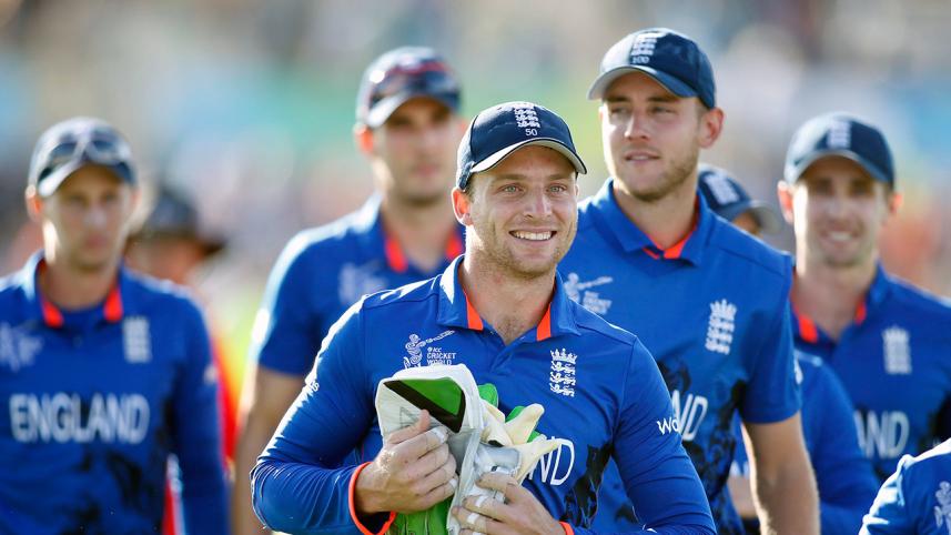 England's Jos Buttler smiles as he walks with team mates 