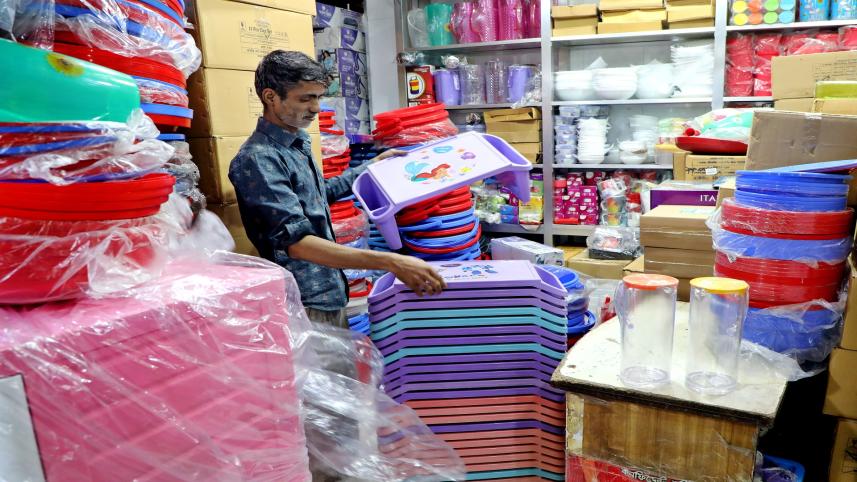 A shopkeeper in Dhaka’s New Market is seen handling small plastic tables at his shop, which is packed with various plastic goods. Experts yesterday urged to introduce a national action plan to promote recycling of plastic products to boost exports. 