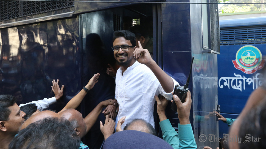 a_convict_in_the_holey_artisan_cafe_attack_case_smiles_and_points_at_the_crowd_from_the_prison_van._photo-anisur_rahman.jpg