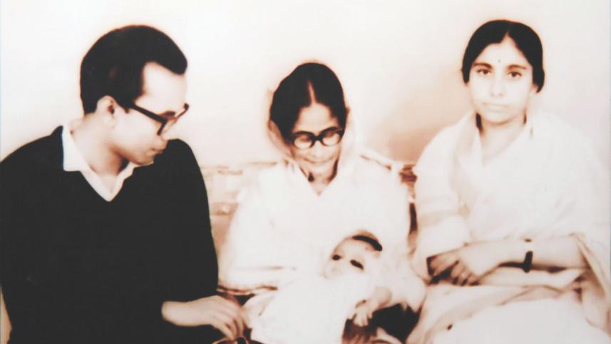 His mother holding her new born granddaughter