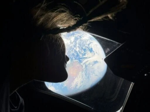 This handout picture by an Artemis II crew member provided by NASA shows Artemis II mission specialist Christina Koch looking back at earth through the window of the Orion spacecraft on April 2, 2026. Photo: AFP
