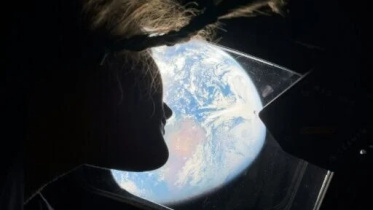 This handout picture by an Artemis II crew member provided by NASA shows Artemis II mission specialist Christina Koch looking back at earth through the window of the Orion spacecraft on April 2, 2026. Photo: AFP