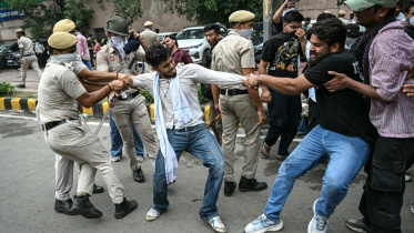 Activists and supporters of the Cockroach Janta Party (CJP) clash with police personnel during a protest demanding the resignation of India's Education Minister Dharmendra Pradhan over alleged NEET exam irregularities in New Delhi on July 20, 2026.