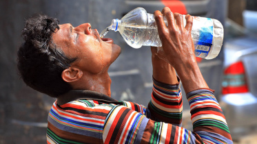 A worker drinking water in a hot summer day