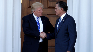 US President-elect Donald Trump shakes hands with former Massachusetts Governor Mitt Romney