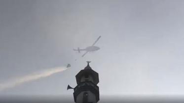 Helicopters are used to spray water and douse the fire that started at Chawkbazar in Dhaka