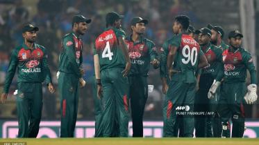 Bangladesh players celebrate after the wicket of Indian batsman Shikhar Dhawan