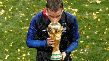 France's Antoine Griezmann kisses the trophy to celebrate winning the World Cup 2018