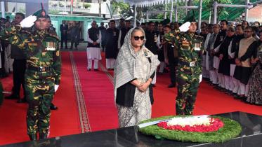 PM Sheikh Hasina stands in solemn after placing wreaths at the portrait of Bangabandhu 