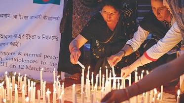 Candles are lit at Central Shaheed Minar for US-Bangla Airlines Plane Crash 