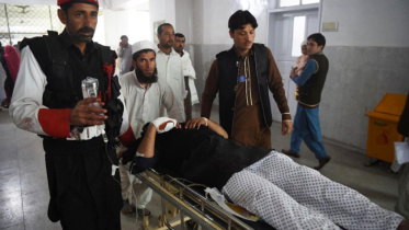 Medics move an injured member of the security personnel at a hospital in Peshawar