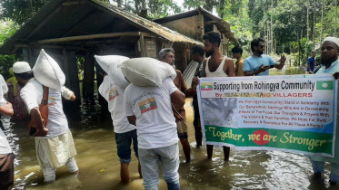 Rohingyas stand beside flood affected people.jpg