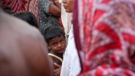 A boy stands with his mother inside a makeshift shelter camp in Goalpara district in the northeastern state of Assam, India, July 18, 2025. Photo: Reuters