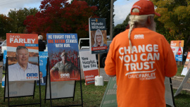 Campaign signs depicting One Nation candidate David Farley and former Australia soldier Ben Roberts-Smith are displayed outside a pre-polling centre ahead of the Farrer by-election in Albury, Australia, May 6, 2026. Photo: Reuters