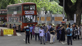Group of students waiting at the bus stop in the Dhaka University campus.