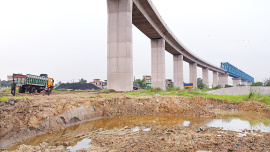 Large pits have emerged after soil was extracted from beneath the Padma rail link bridge in the Aliganj area of Narayanganj’s Fatullah. The district administration yesterday halted the excavation following locals’ concerns that the work could damage the structure. The photo was captured on June 16. Photo: Palash Khan 