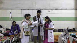 Medical interns examining reports. 
