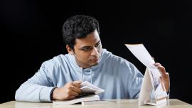 A student flipping through the pages of a calendar.