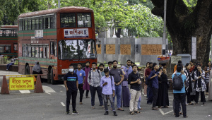 Group of students waiting at the bus stop in the Dhaka University campus.
